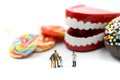 Miniature people : Doctor dentist speaks about student and children with desserts,Fun eating and healthcare  concept Royalty Free Stock Photo