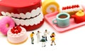 Miniature people : Doctor dentist speaks about student and children with desserts,Fun eating and healthcare concept Royalty Free Stock Photo