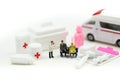 Miniature people : Doctor and Paramedic attending to patient in ambulance,Medicine ambulance concept