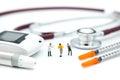 Miniature people: doctor standing with stethoscope and syringe a