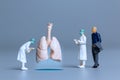 Miniature Doctors study and treat large human lungs, World Health Day concept