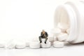 Miniature people - Elderly people posing in front of pills