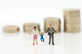 Miniature people, family figure standing on top of stack coins . Image use for background retirement planning, Life insurance Royalty Free Stock Photo