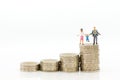 Miniature people, family figure standing on top of stack coins . Image use for background retirement planning, Life insurance Royalty Free Stock Photo