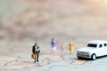 Miniature people: Family walking hand in hand with on world map Royalty Free Stock Photo