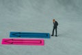 Miniature people figure as businessman thinking with the arrow o Royalty Free Stock Photo