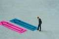 Miniature people figure as businessman thinking with the arrow o Royalty Free Stock Photo