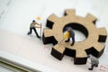 Miniature people with gear cog symbol on calendar, Business management and working process concept