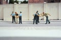 Miniature people of a girl or woman arrested by police and military security officer Royalty Free Stock Photo