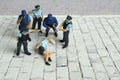 Miniature people of a girl or woman arrested by police and military security officer