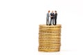 Miniature people on gold coin and shaking hand,business concep Royalty Free Stock Photo