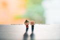 Miniature people, grandfather and grandmother standing on blurry background Royalty Free Stock Photo
