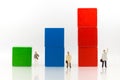 Miniature people :Graph showing performance, profits generated by the business. Image use for business concept