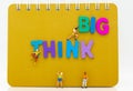 Miniature people : Group Athletes climb on book with THINK BIG text wooden. Image use for Activities, travel, business concept. Royalty Free Stock Photo