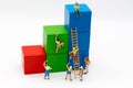 Miniature people : Group Athletes use stairs to climb colorful wood building. Image use for Activities, travel, business concept