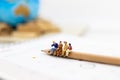 Miniature people : Group business sitting on the pencil. Image use for education, business concept