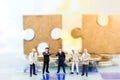 Miniature people, Group Businessmen standing on the chess game with jigsaw background, thinking solution for the business game
