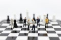 Miniature people, Group Businessmen standing on the chess game, thinking solution for the business game, use as a business