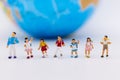 Miniature people : Group children standing with world map. Image use for study international, back to school concept Royalty Free Stock Photo