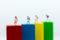 Miniature people: Group childrens stand on wood block color. Image use for education concept Royalty Free Stock Photo