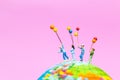 Miniature people : Happy family holding balloon on The globe wit Royalty Free Stock Photo