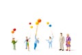 Miniature people : Happy family holding balloon on white background Royalty Free Stock Photo