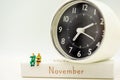 Miniature people: Happy senior couple standing on white wooden box with clock. Retirement, emergency plan Concept Royalty Free Stock Photo