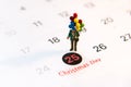 Miniature people holding balloon stand on the calenda, Merry Christmas. Royalty Free Stock Photo