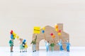 Miniature people holding Welcome signs at front of the home Royalty Free Stock Photo
