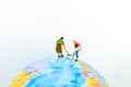 Miniature people : Housekeeper clean world map. Image use for big cleaning day