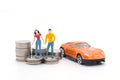 Miniature people,husband and wife standing with car and stack co