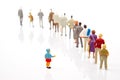 miniature people. little girl stands against the background of other people on a white background. Loneliness and family