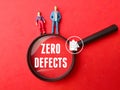 Miniature people,magnifying glass and icon with text ZERO DEFECTS