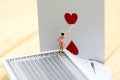 Miniature people : maid clean a heart of Playing cards.