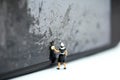 Miniature people : Maid cleaning a wall dirty. Royalty Free Stock Photo