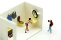 Miniature people : man is hiding behind bathroom Spying. Voyeur