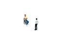 Miniature people : Man sitting a chair with businessman.