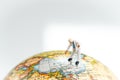 Miniature people man standing and pointing on China map on globe with white copy space using as China economic prosperity, trade Royalty Free Stock Photo