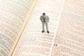 Miniature people. man stands on the bible text. search for the path of life. I am the way