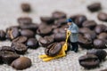 Miniature people, a man worker using pallet jack to lift heavy r Royalty Free Stock Photo