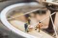 Miniature people : mechanics repairing bicycle Royalty Free Stock Photo