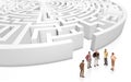 Miniature people meeting in front a maze