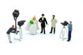 Miniature people: Moderator are interviewing love couple with camera and video capture. Image use for Entertainment Industry