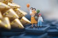 Miniature people: mom and son holding balloon Royalty Free Stock Photo