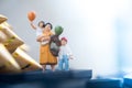 Miniature people: mom and son holding balloon Royalty Free Stock Photo