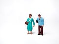 Miniature people msn and woman carrying bags