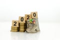 Miniature people, Old couple figure sitting on top of stack coins using as background retirement planning, Life insurance concept Royalty Free Stock Photo