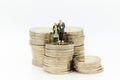 Miniature people, old couple figure standing on top of stack coins . Image use for background retirement planning, Life insurance Royalty Free Stock Photo