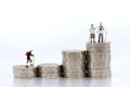 Miniature people: Old people standing on top of stack coins . Image use for background retirement planning, Life insurance concept