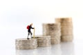 Miniature people: Old people standing on top of stack coins . Image use for background retirement planning, Life insurance concept Royalty Free Stock Photo